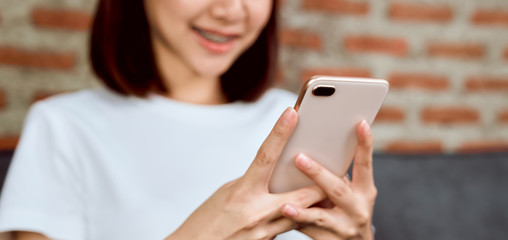 Close-up of woman holding a smartphone and using online social on lifestyle. Technology for communication concept.