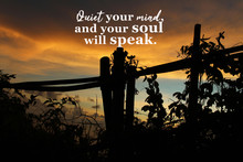 Inspirational Quote - Quiet Your Mind, And Your Soul Will Speak. On Natural Abstract Background Of Dramatic Colorful Sunset Sky Clouds Over The Mountain, With Wild Plants & Wooden Fence Silhouette.