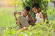 Two boy in the countryside is studying via wireless internet.