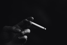 Close-up Of A Hand Holding Cigarette