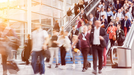 Many people go on escalator to business trade fair