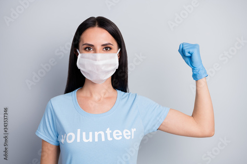 Close-up portrait of her she nice-looking attractive lovely pretty strong girl medic doc voluntary work worker job demonstrating muscles power isolated over grey pastel color background
