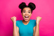 © deagreez - Closeup photo of crazy funky dark skin lady two buns raise fists celebrating amazing success achievement yelling loud wear blue casual t-shirt isolated bright pink color background