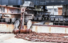 Rusty Metallic Chains By Ship Moored At Harbor