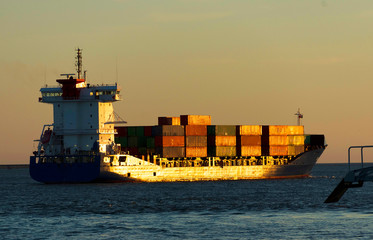 Huge container cargo ship in sunset light