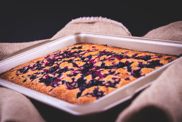 freshly baked pie in a pan with raspberries and cherries