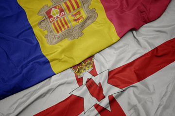 waving colorful flag of northern ireland and national flag of andorra.