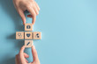 © oatawa - Health medical Insurance Concept, Two Hands arranging wood cube with medical symbol on pastel blue background, copy space.