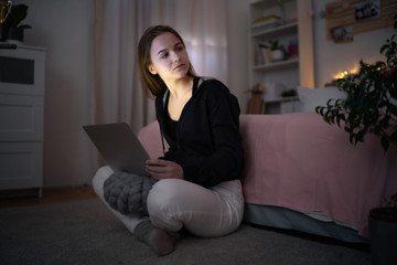 Wall Mural - Worried young girl with laptop sitting and smiling, online dating concept.