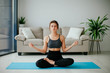© Катя Іваськевич - young woman doing yoga. yoga at home. meditation at home.