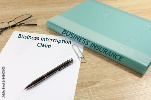 Business Interruption Claim Concept - with folder that reads \'Business Insurance\'