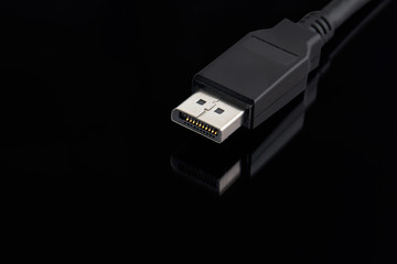 Fototapete - display port cable plug close up over black background. desktop gaming and tv concept.