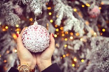 Human Hand Holding Christmas Bauble
