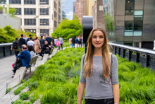Girl Exploring The High Line Park In Manhattan New York. The Urban Park Is Popular By Locals And Tourists Built On The Elevated Train Tracks