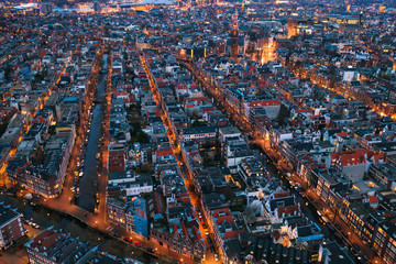 Wall Mural - Aerial evening Amsterdam view with narrow canals, streets and historic buildings, view from above, Netherlands.