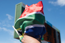 Cropped Hands Holding South African Flag Against Scoreboard
