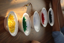 High Angle View Of Various Beads In Bowls On Table