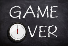 Game Over Text Written With White Chalk On Chalkboard Or Blackboard.Time Is Over Concept