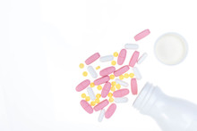 Pills Spilling Out Of Pill Bottle. Assorted Pharmaceutical Medicine Pills, Tablets And Capsules On White Background. Antiretrovirals On White Background.