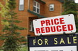 Home For Sale Price Reduced Sign during  slowing economy 