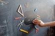 © Юлия Ефимова - Back to school concept. Chalkboard background. Hand and education tools.