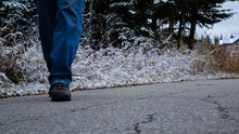Person Walking On A Public Path Close Of Of Shoes