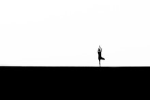 Silhouette Woman Practicing Tree Pose Against White Background