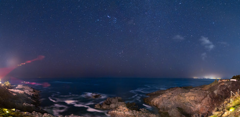 Wall Mural - a view of the milky way and the stars at a starry night above the sea in the pacific ocean with the 