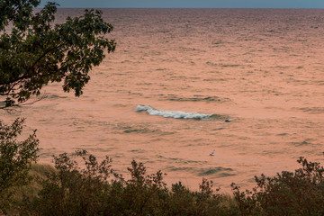 Wall Mural - Lake Michigan waves at sunset shot from on top of the dunes of Saugatuck Michigan