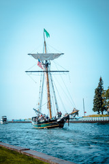 Wall Mural - Tall ship setting sail from a harbor