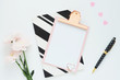 © Olga - .a pink clipboard, a black and white striped notebook, three pink chrysanthemum flowers, a black polka dot pen and plastic hearts..