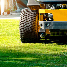Lawn Mower Park In Green Grass Field, Zero Turn Lawn Mower.

