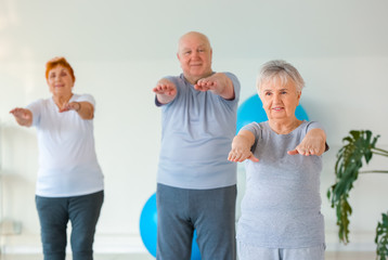 Wall Mural - Elderly people exercising in gym