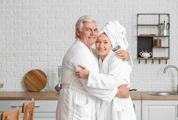 Poster - Mature couple in bathrobes at home