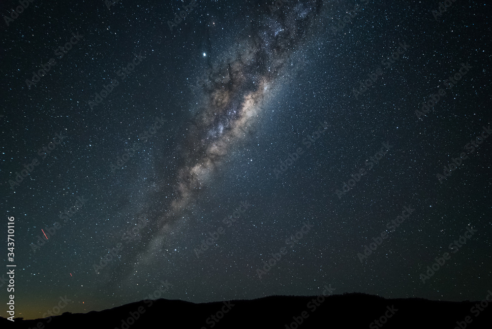 A night time photo of the Milky Way galaxy against a dark starry sky in ...