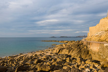 Rock And Emerald Sea Of The Coast Of Dinard With A View Of Saint Malo, Brittany, FranceSaint Malo
