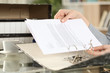 © PheelingsMedia - Girl hands putting documents on a ring binder