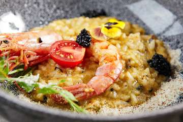 Canvas Print - Risotto with seafood in gray bowl  closeup