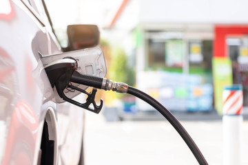 Close-up hands refueling in car,The petrol station staff is refilling the car for customers,Refill fuel in car at gas station,Focus hands refilling.