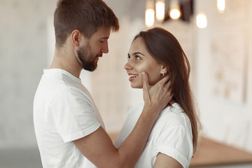 cute couple in a bedroom. lady in a white t-shirt. pair at home