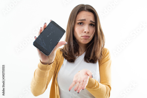 Fotografía Beautiful girl is upset about the broken phone