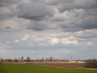 Wall Mural - spring village against the sky with clouds