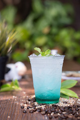 Poster - a cup of sweet soda ice on wooden floor