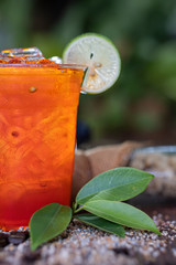 Poster - a glass of cool lemon tea on wooden floor