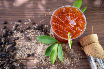 Poster - a glass of cool lemon tea on wooden floor