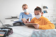 © astrosystem - Child home studying education, homeschooling, with private tutor / mother with protective mask in the time of viruses, flu and seasonal pandemic, healthy approach in social contact.
