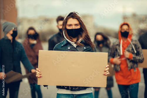 Fotomural A group of people with mask and posters to protest The protest of the population against coronavirus and against the introduction of quarantine Meeting about coronavirus and people rights