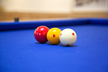 Close-up Of Cue Balls On Blue Billiards Table