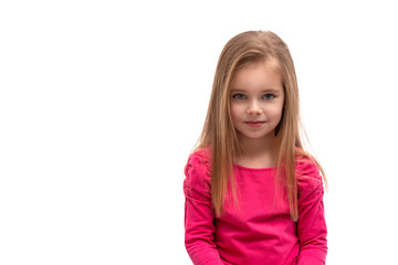 Studio shot of a cute blonde girl with long hair and blue eyes, isolated