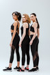 © LIGHTFIELD STUDIOS - beautiful and multicultural women in sportswear standing on white